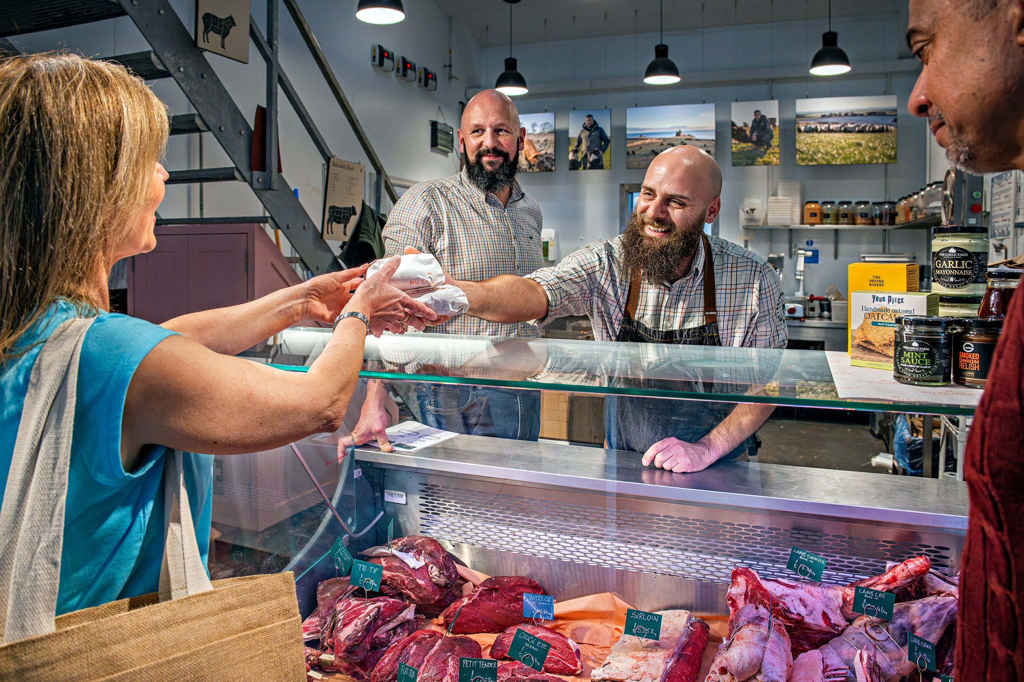 Shopper purchasing meat from butchery counter