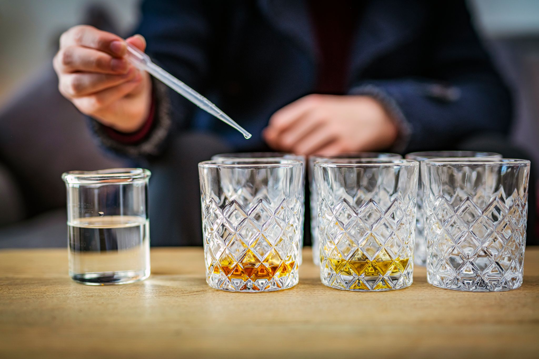 Whisky being mixed in glasses