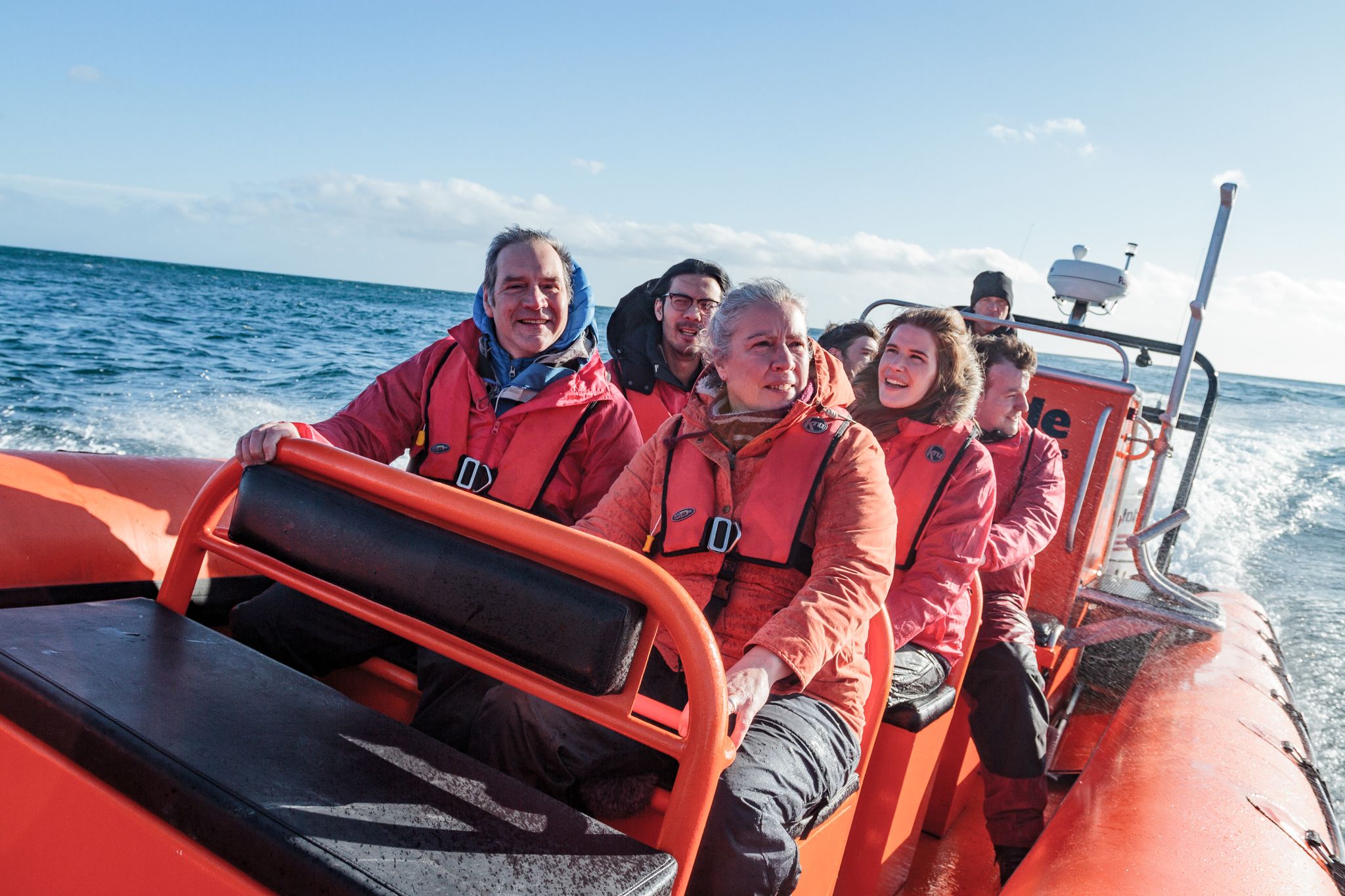 Group on power rib at sea