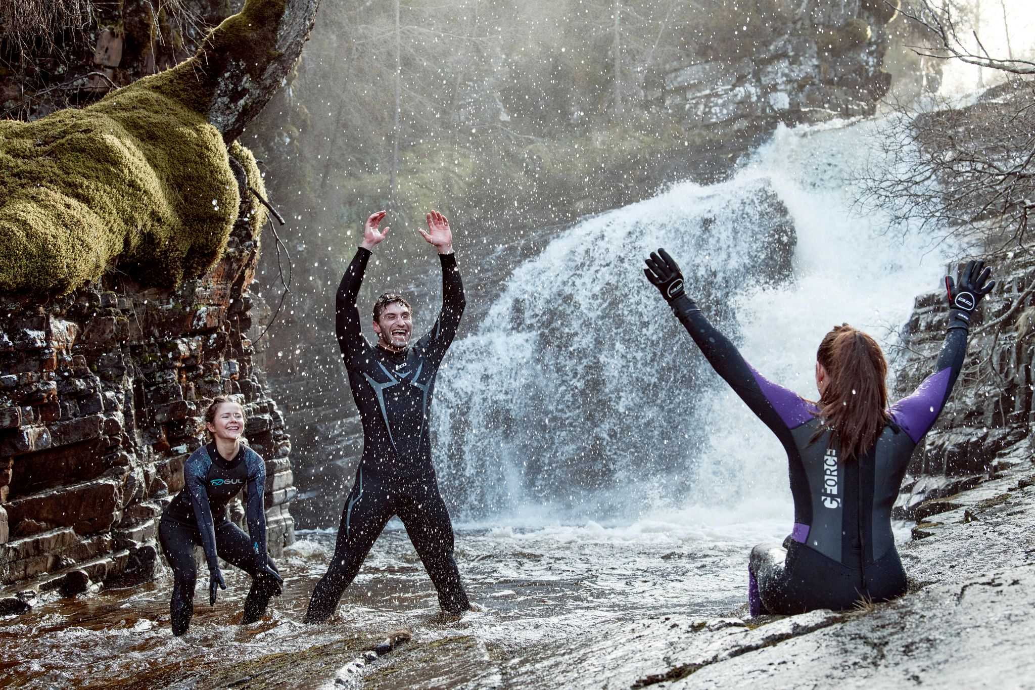 People in wetsuits wild swimming