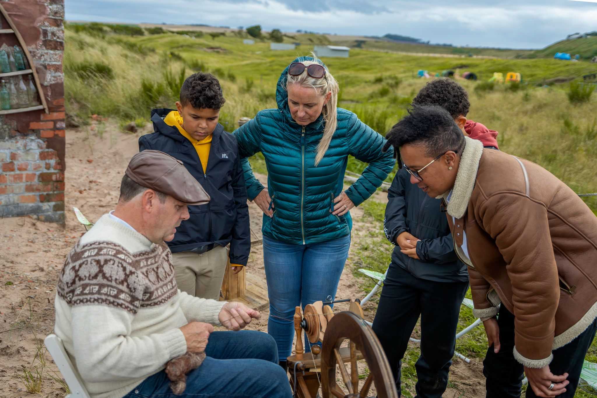 Visitors watching a farming demonstration