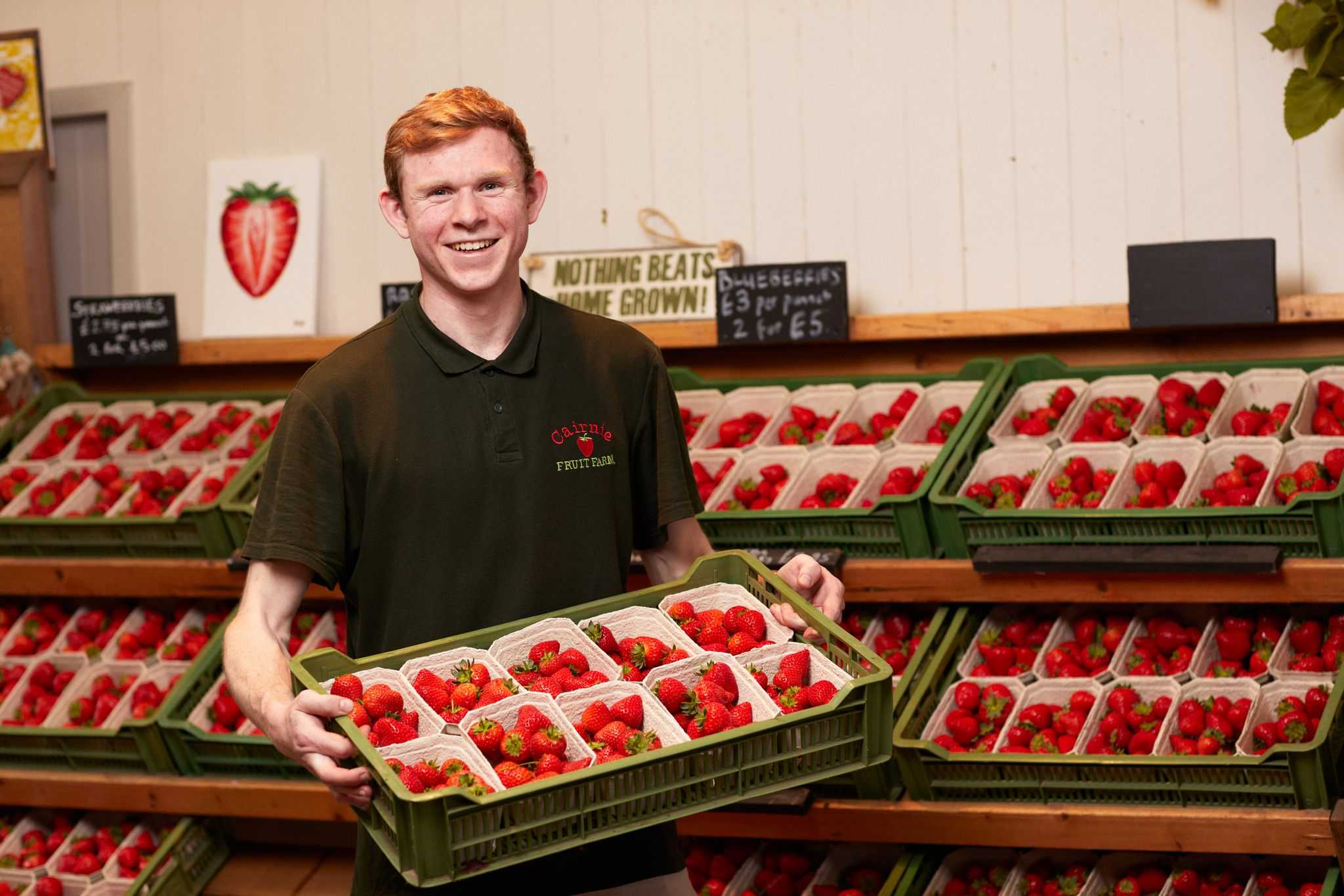 Man holding a tray of berries