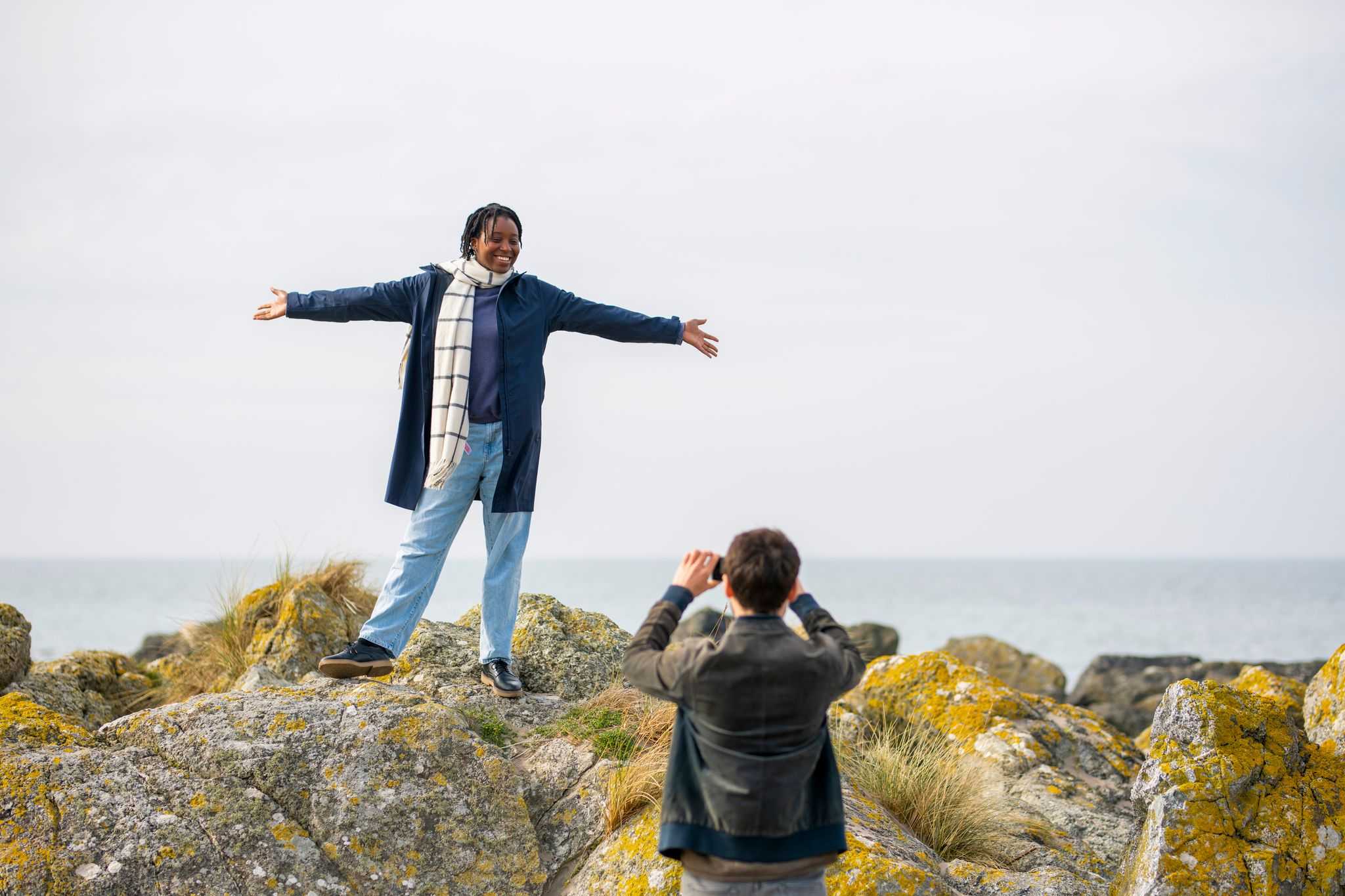 Couple taking pictures on coastal dunes