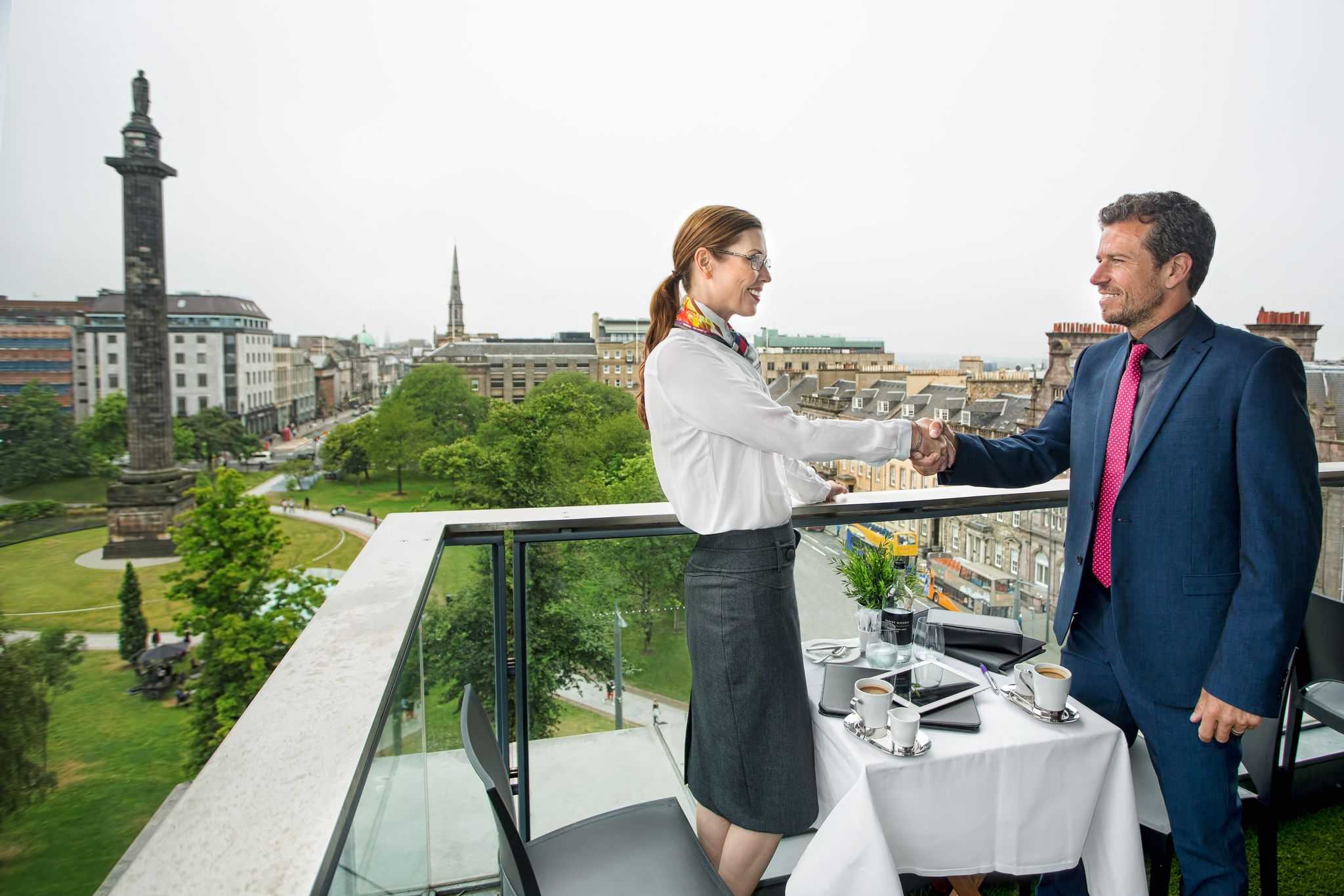 Pair having food and drinks on outdoor rooftop terrace of Harvey Nicols